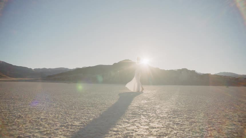 A woman standing in a desert