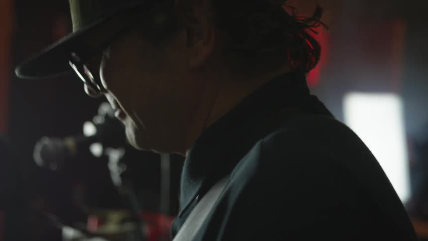 A musician nods his head while playing an instrument
