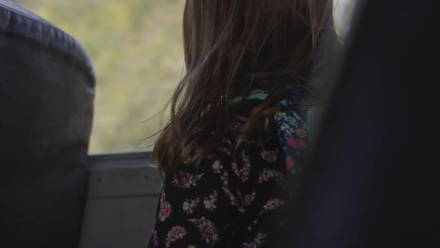 Girl sits in bus
