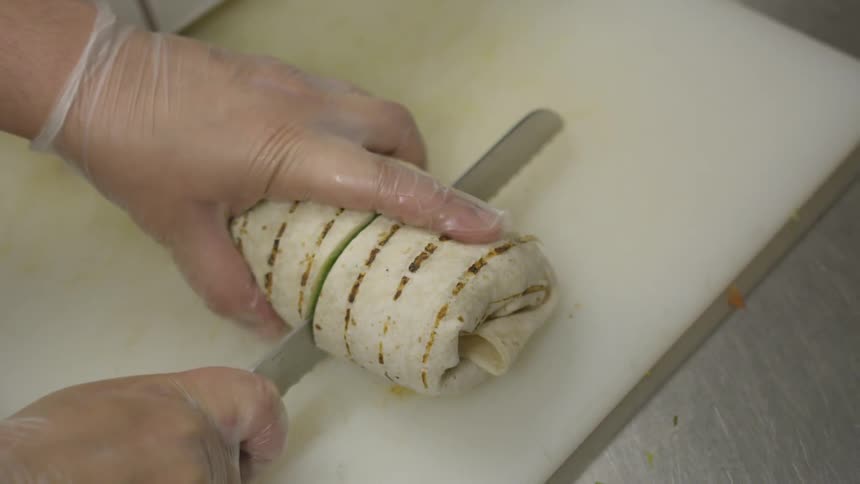 A knife cuts through a wrap
