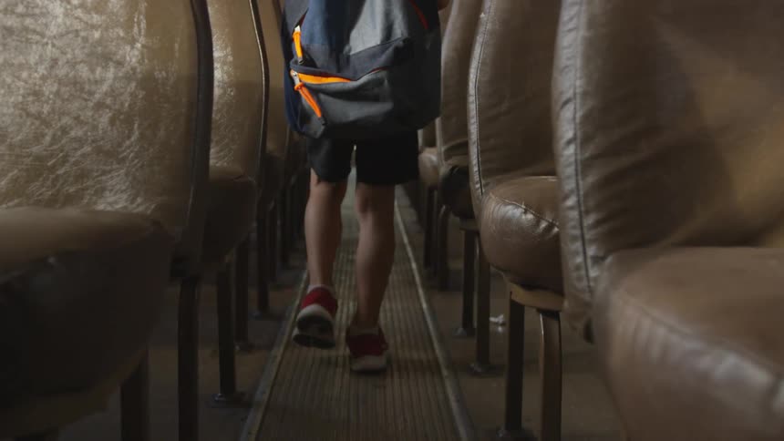 Man wearing backpack walks in the hallway