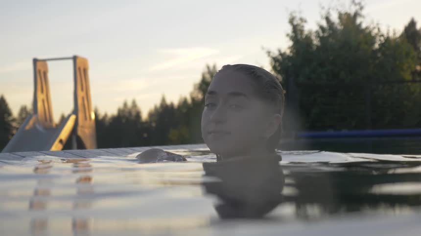A female enjoys a pool in the morning