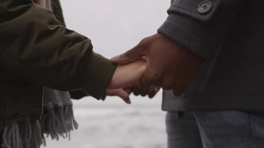 Couple holding hands on a beach