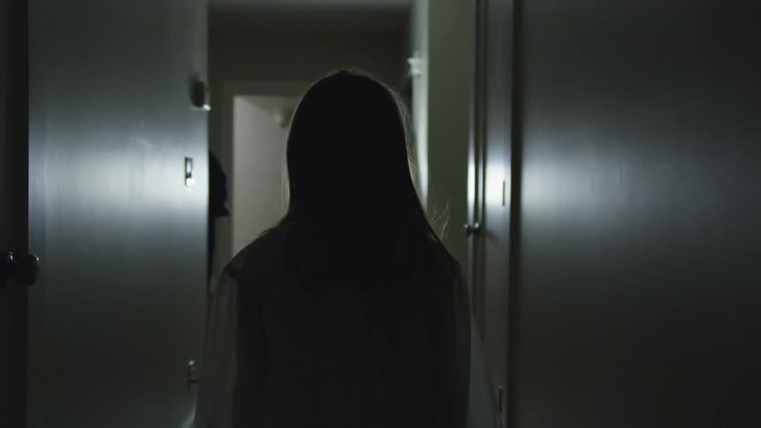 A woman is indoors standing still