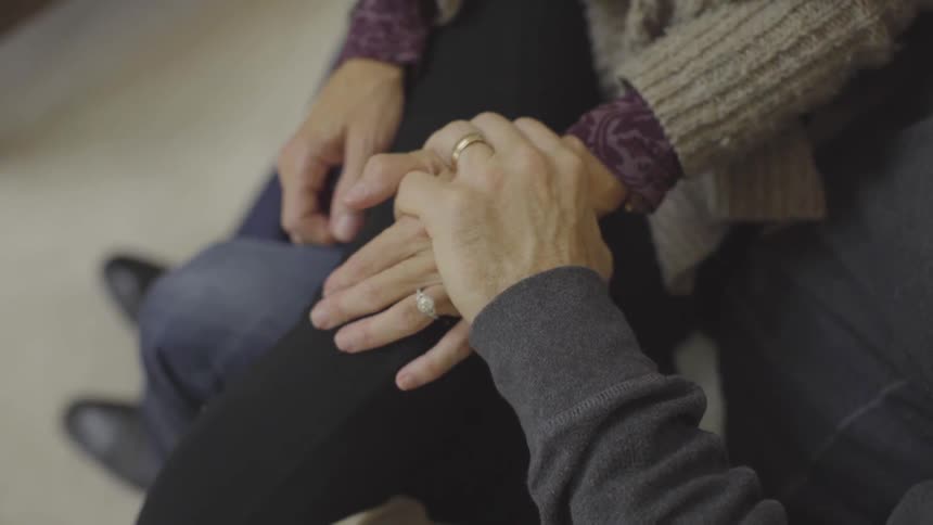 A woman and man are holding hands