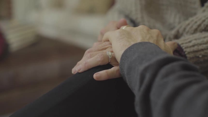 A woman and man are holding hands