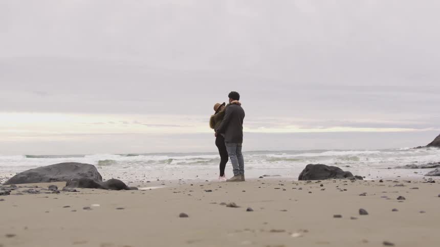 Man and woman hugging on a beach