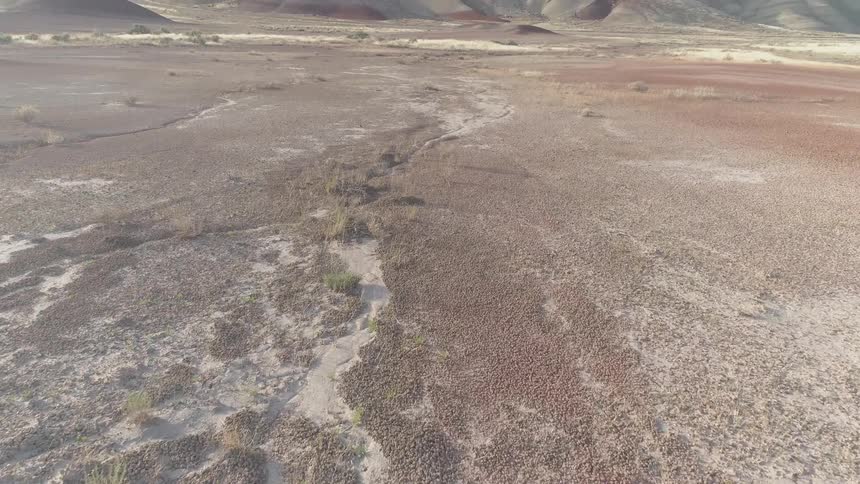 Dry fields leads to a tall hill