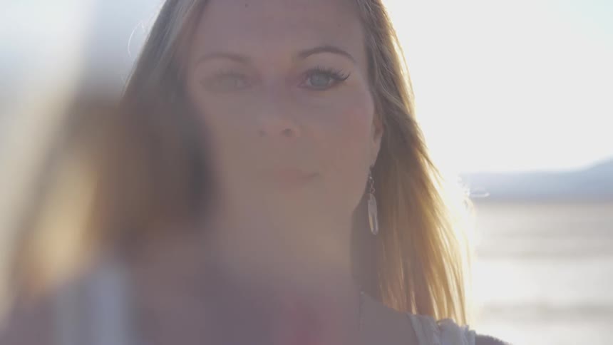 A woman is looking and standing outside