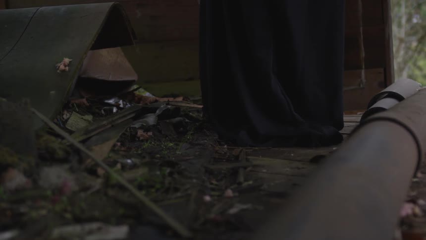 A person stands near debris on the ground