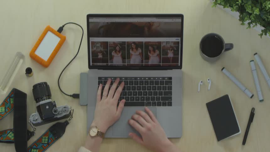 Person types and scrolls on a laptop