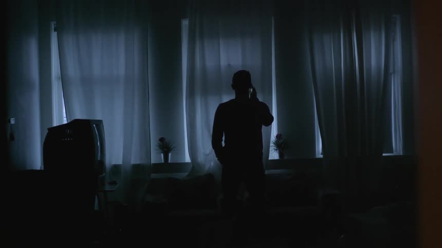 A man stands in the dark