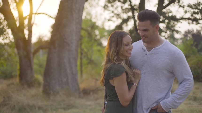 A man has his arm around a woman