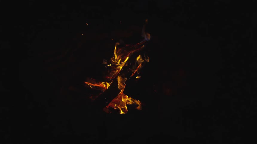A log that is on fire in a fire pit