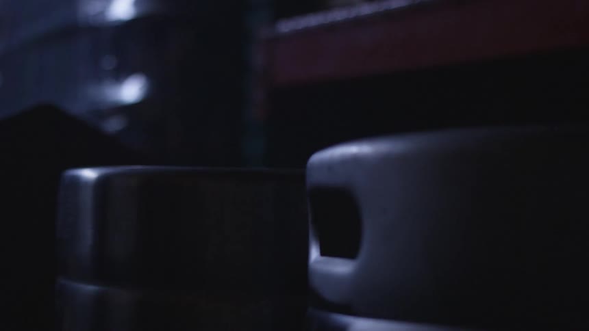 The kegs sit in the dark brewery