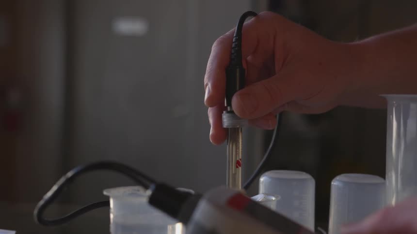 A person is mixing something with an instrument