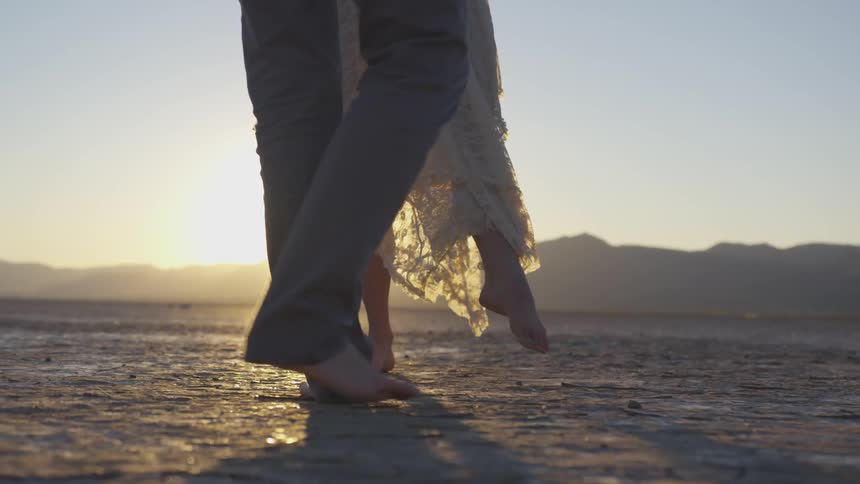 A man and woman dance together outside