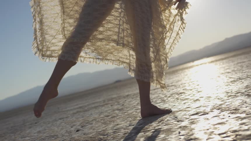 Woman dancing on a dry desert bed