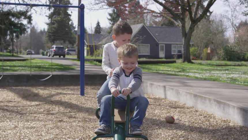 Four children playing on a seesaw