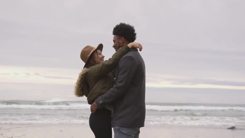 Man and woman hugging on a beach