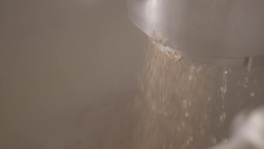The water is slowly spraying from the metal hose