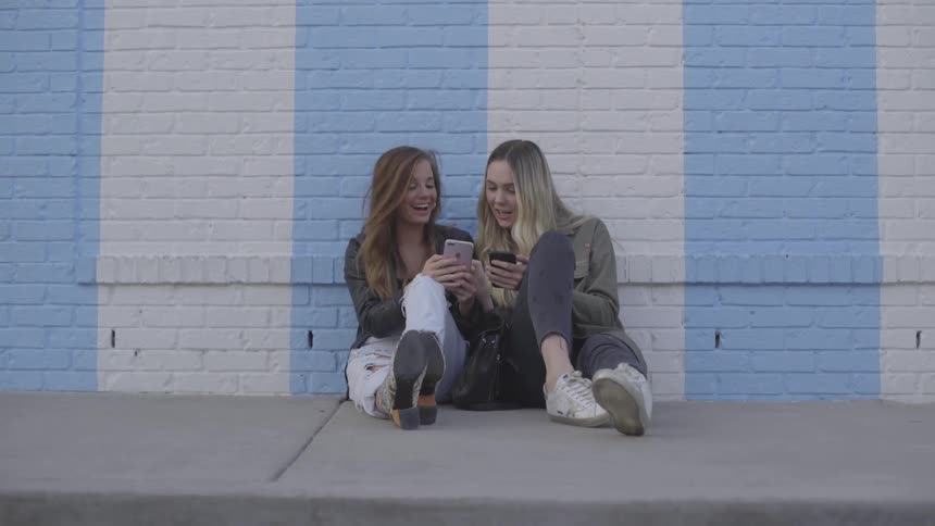 Friends On Their Phones And Taking Selfies