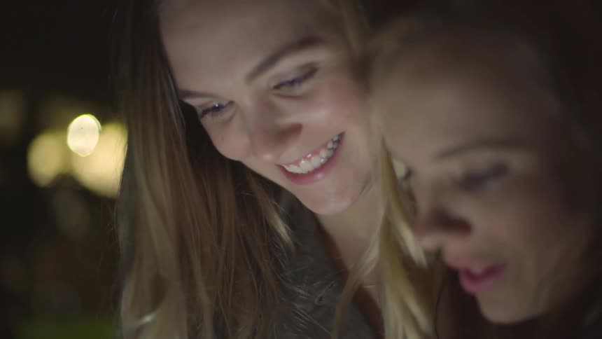 Two women look at something on the ground