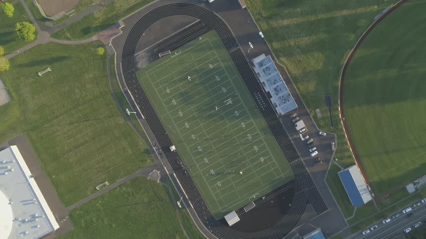 A football pitch can be seen far below