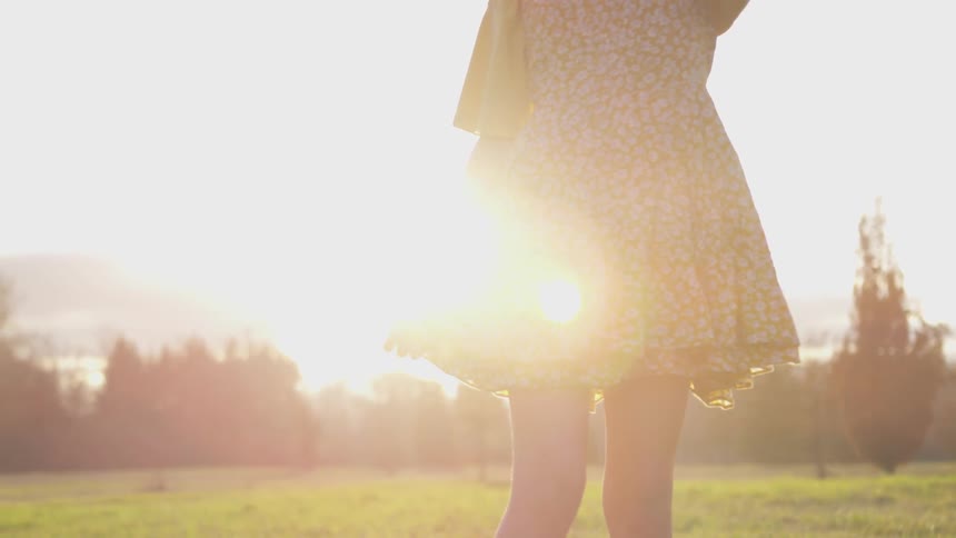 Girl Reading A Bible And Walking In A Field