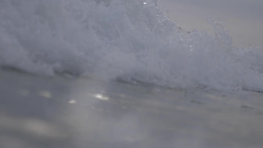 Ocean waves crashing across camera