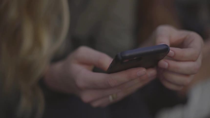 Close up of woman's hands using smartphone