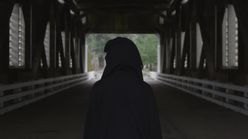 Hooded Figure On Bridge