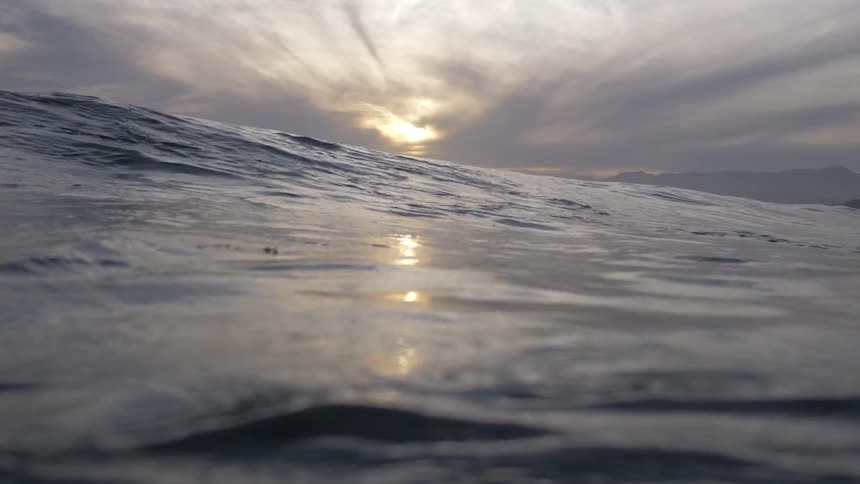 Ocean waves swell in front of camera