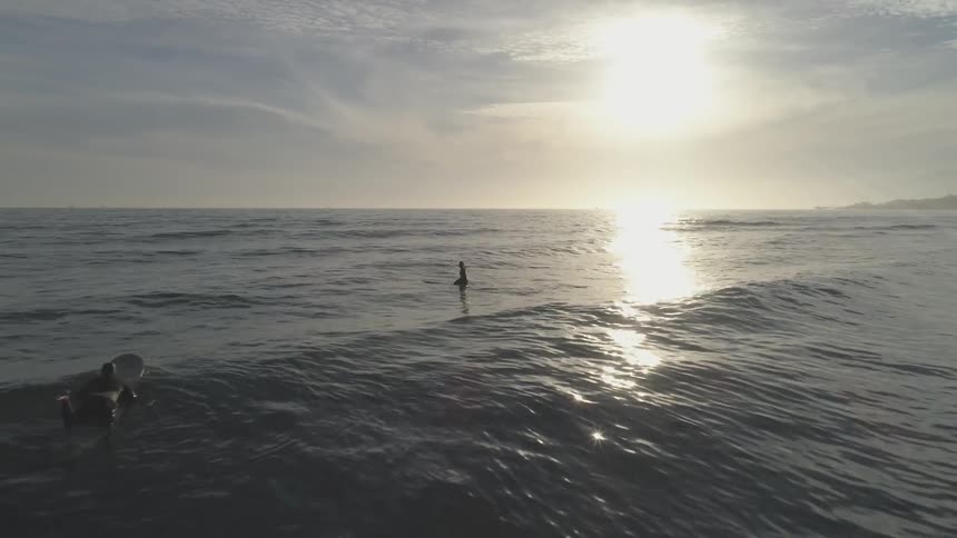 A view of the ocean with people in the water