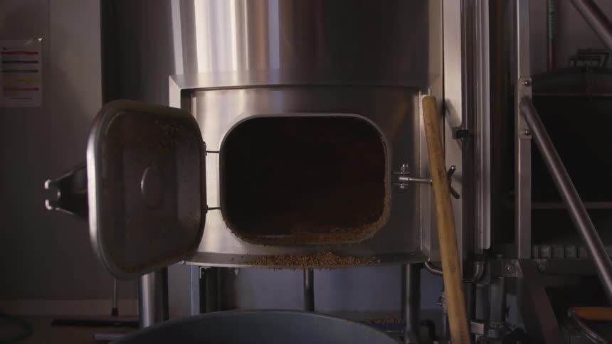 A vat door sits open inside a brewery