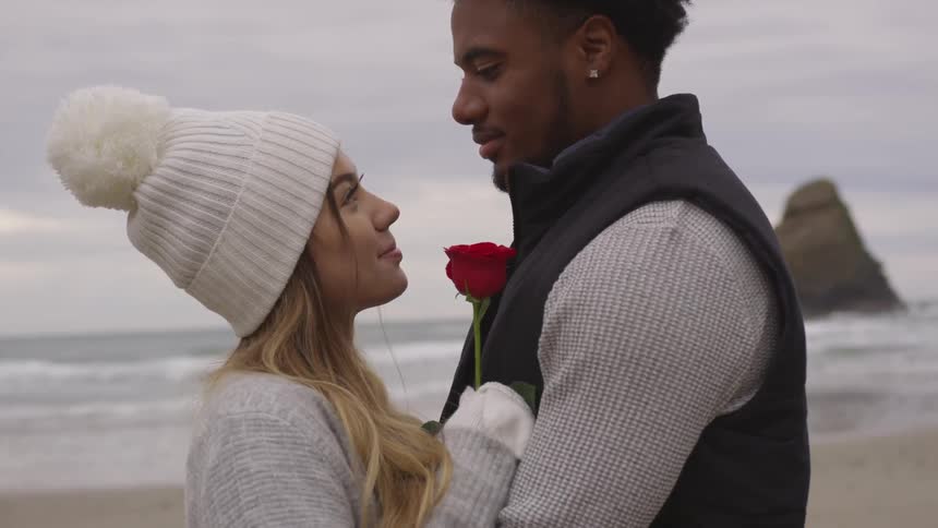 A man and woman holding each other outside