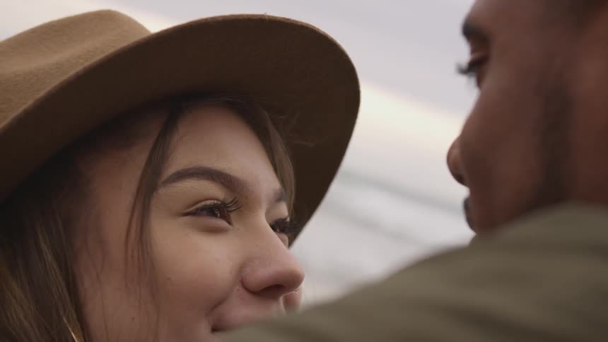 A woman smiles at the man in front of her