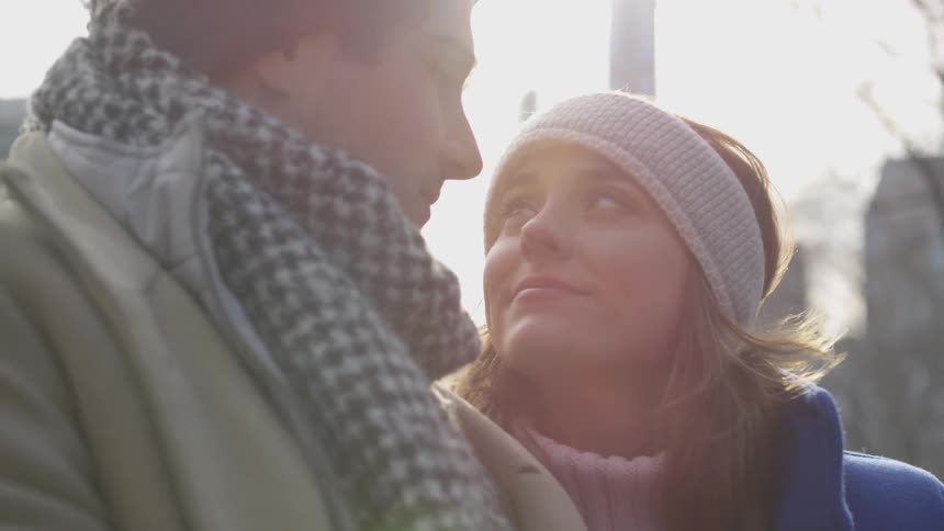 A man and woman stare lovingly at each other outside in the cold