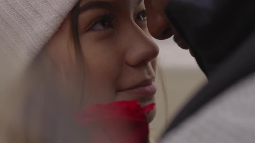 A woman looks at a man directly in front of her