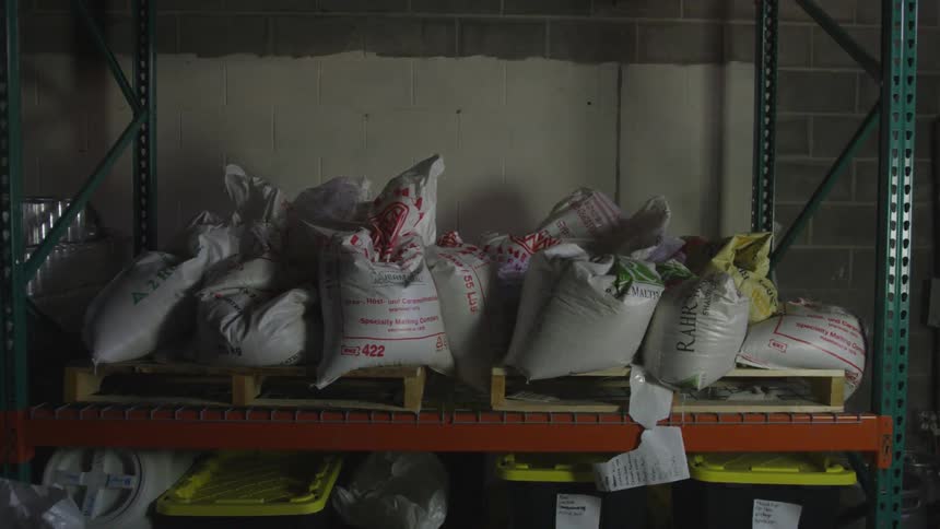 A shelf hold bags of concrete and other products