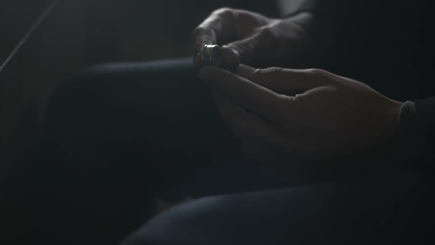 Person takes an object and examines it in their hands