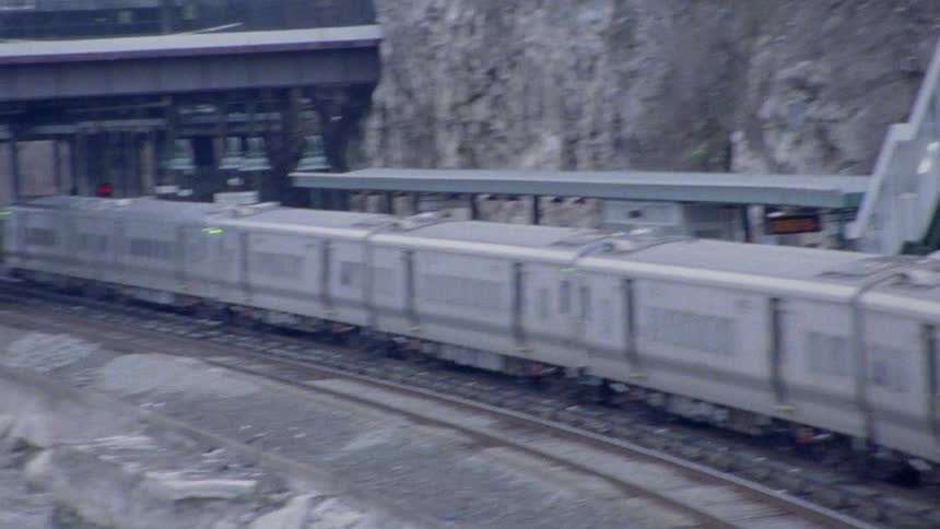 A train riding along its tracks next to a river