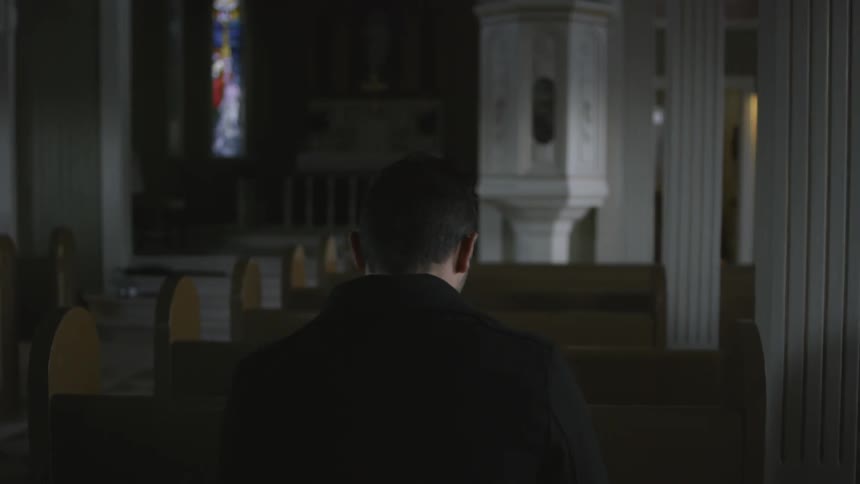 A man sitting alone in a chapel