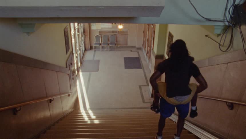 A man gives a piggyback to someone up and down the stairs