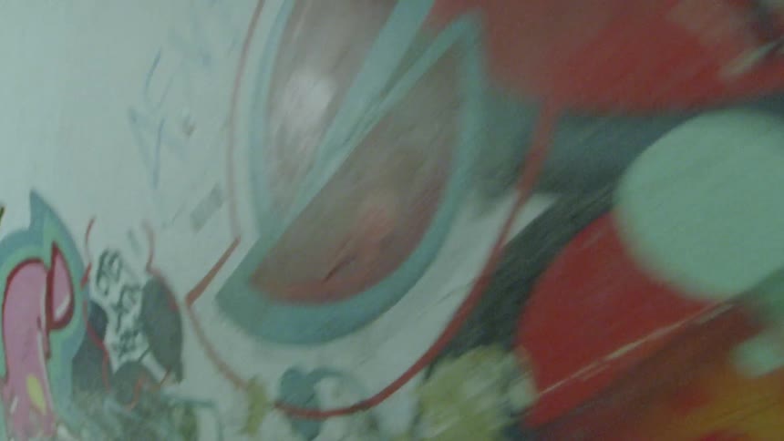 Graffiti covers the tunnel walls