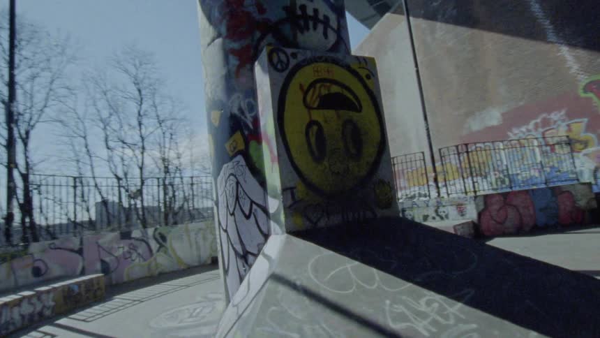 The camera circles the underground graffiti concrete and walkways of a place near everywhere there are troubled teens and concrete walkways
