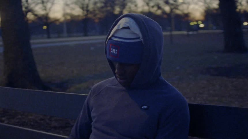 A man sitting in a park reading