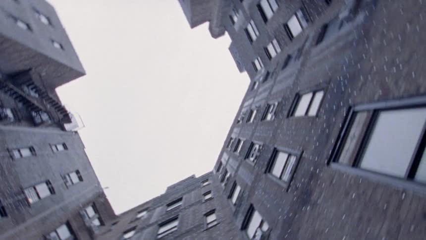The tall apartment buildings have many windows