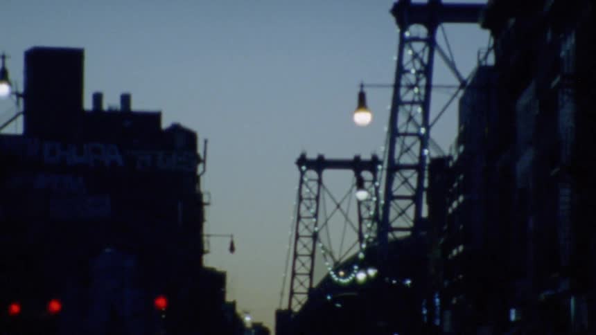 Illuminated bridge in city at dusk