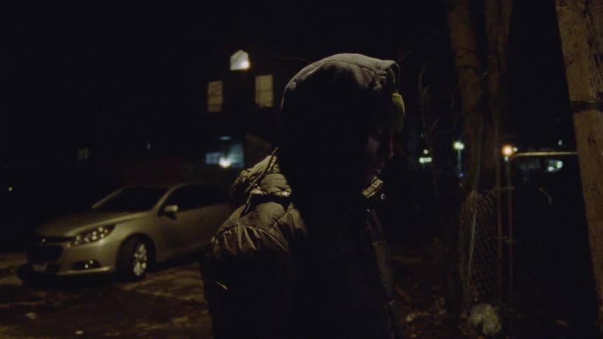 A person wearing warm clothing standing in the street